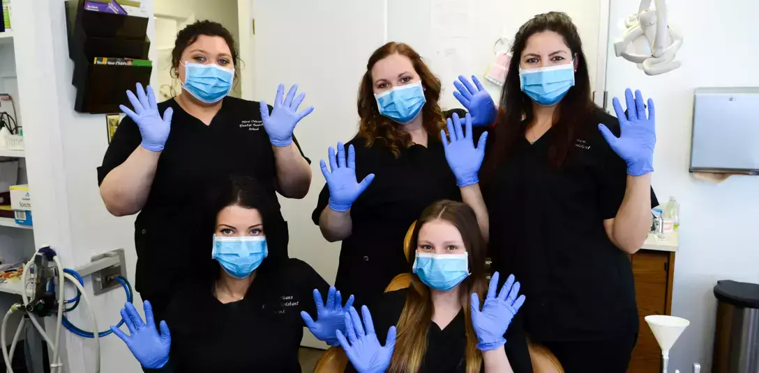 students posing for a group photo with gloves and masks on in dental office students posing for a group photo with gloves and masks on in dental office