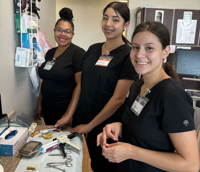 students working with dental assisting equipment in class students working with dental assisting equipment in class
