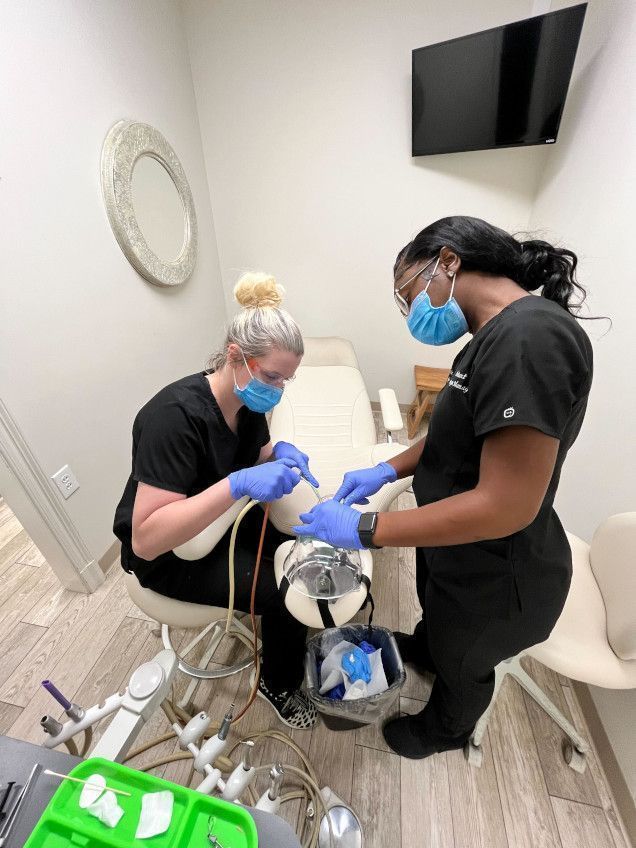 student working with their instructor on dental procedures student working with their instructor on dental procedures