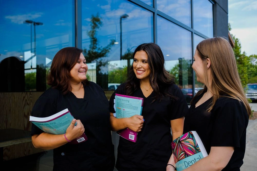 students outside of facility with their workbooks in hand students outside of facility with their workbooks in hand